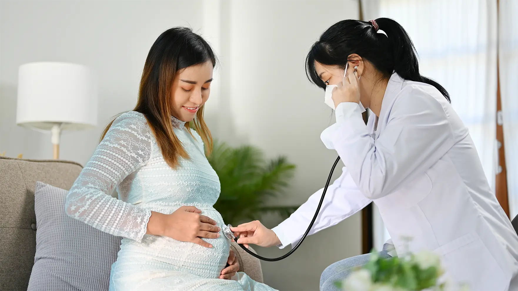 Obstetrician performing a prenatal checkup on a pregnant woman